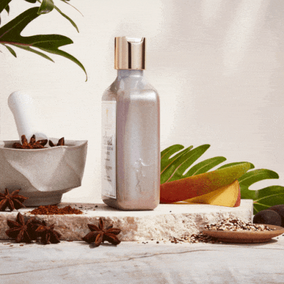 gif of a bottle of rahua scalp exfoliating shampoo rotating in a circle before being dispensed out onto the stone slab|variant:074-oz