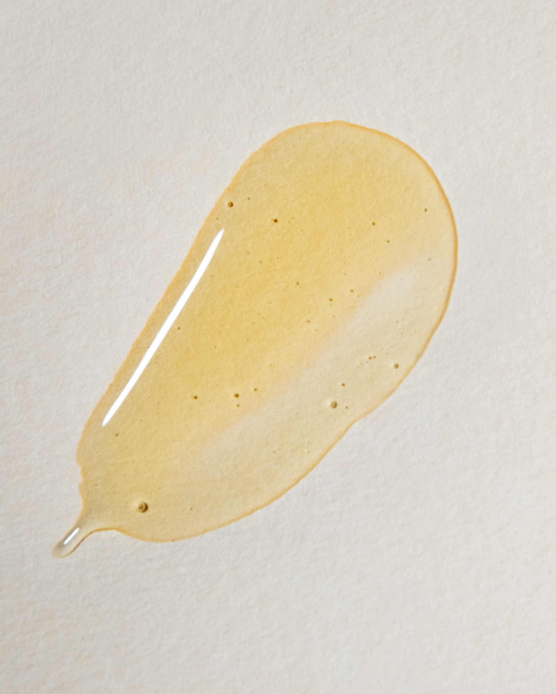 Yellow cream or lotion smear on a beige background|variant:93-oz,18-oz