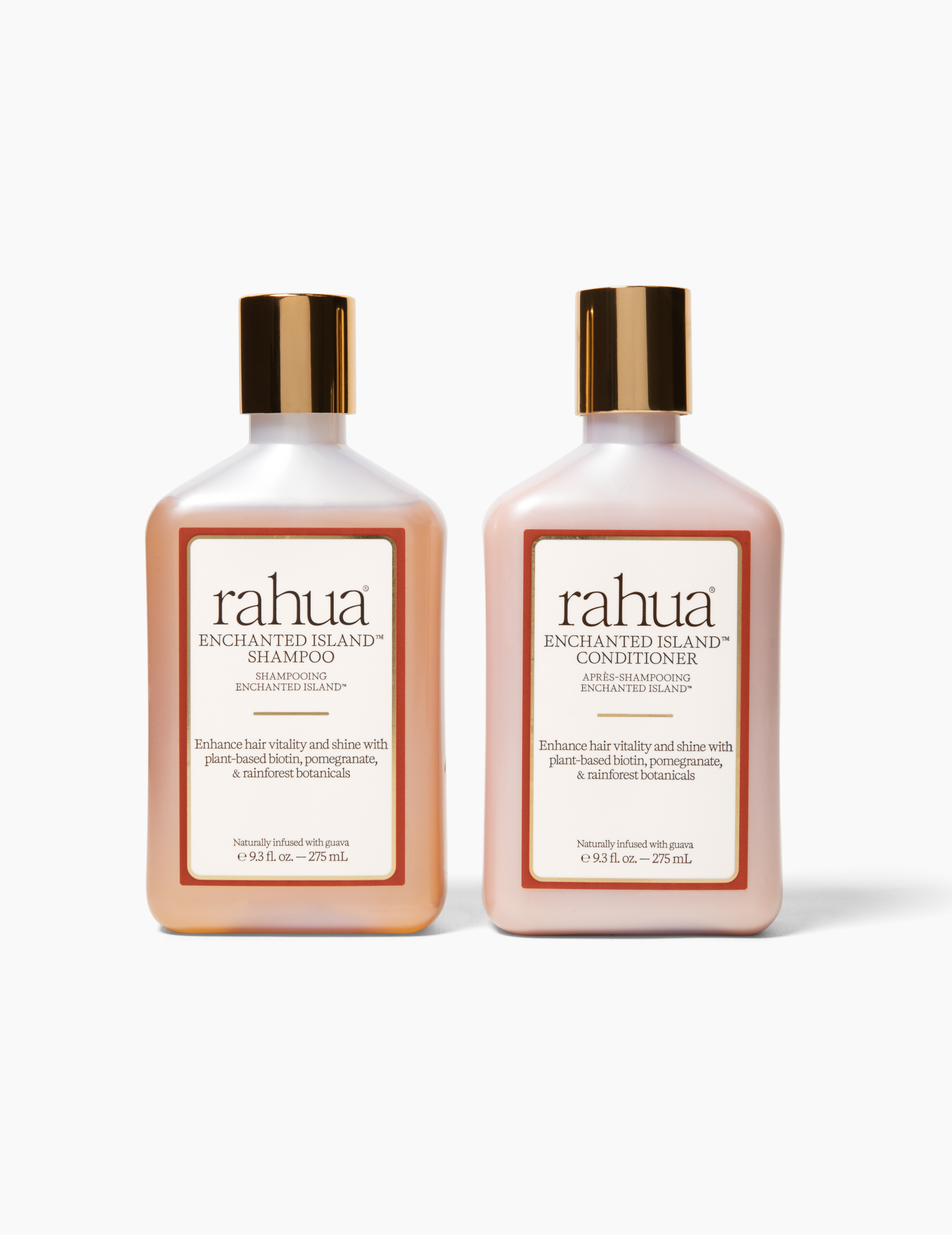 two bottles with gold caps and labels of rahua enchanted island and conditioner on a plain white background, new label with an orange and gold outline with brown black text|variant:93-oz