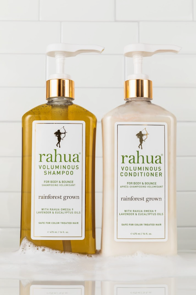 two 16 oz bottles of plastic pumps with gold collars of rahua voluminous shampoo and voluminous conditioner with a white tile background with soap|variant:16-oz