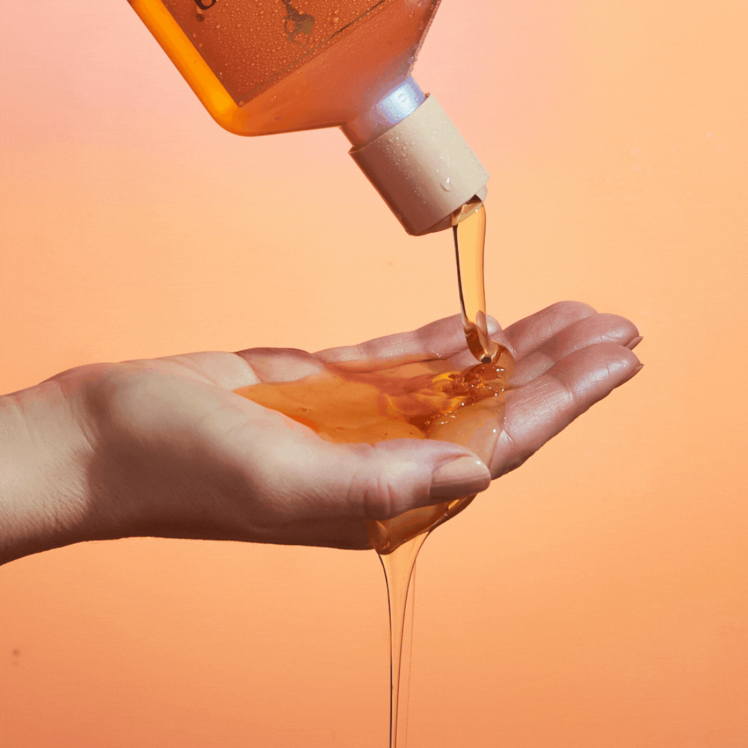 gif of model pouring out enchanted island shampoo on their hand|variant:93-oz