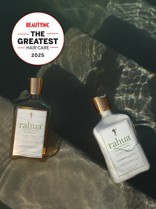 two bottles of plastic with gold caps of rahua voluminous shampoo and voluminous conditioner floating on the surface of a pool on top of concrete stairs with a sticker in the top left of beauty inc the greatest hair care 2025|variant:93-oz
