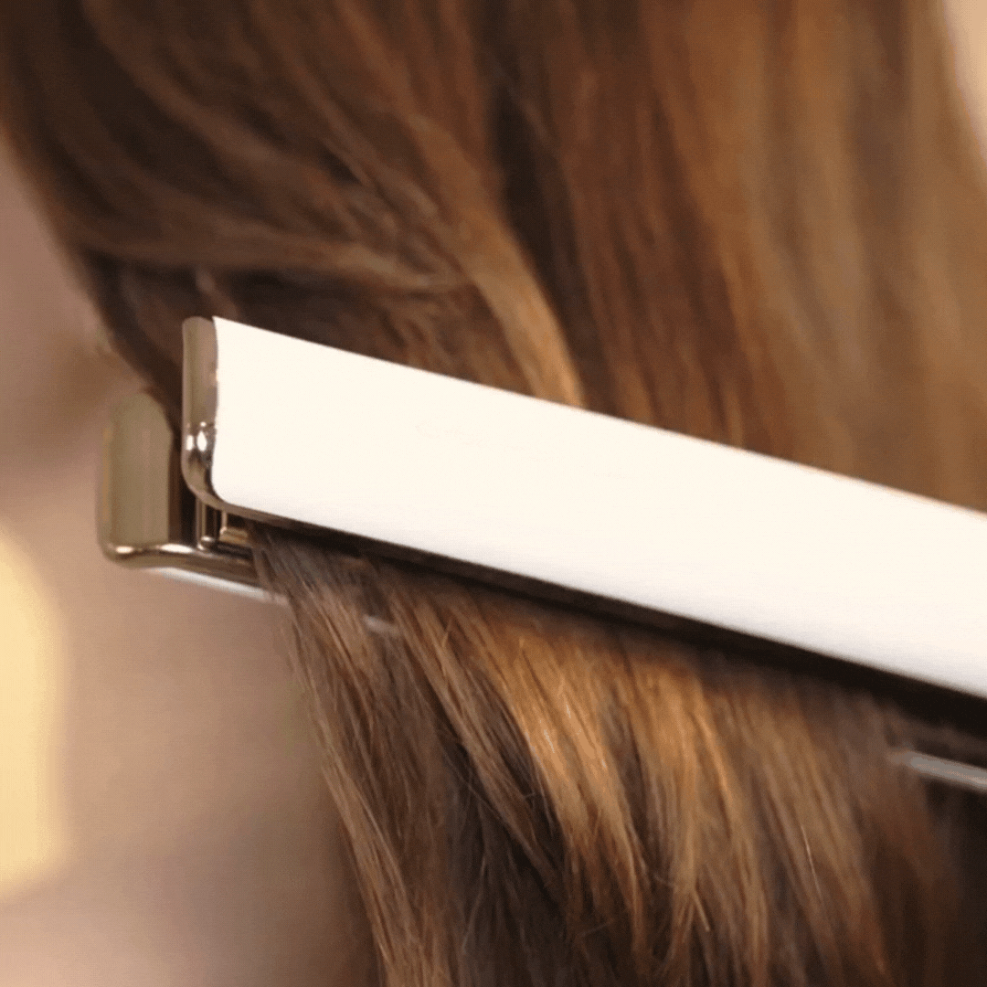 Women doing hair straightening after using Rahua heat protactant shield