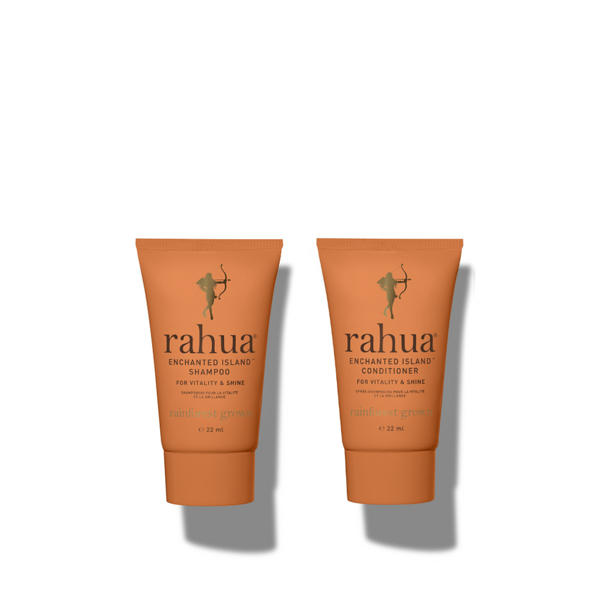 Two bottles of Rahua Enchanted Island hair care products, one labeled as shampoo and one as conditioner, against a white background|variant:074-oz